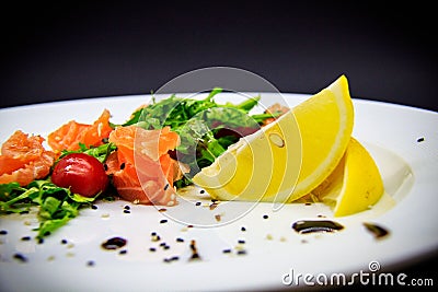 Salted salmon with garnish on black background Stock Photo