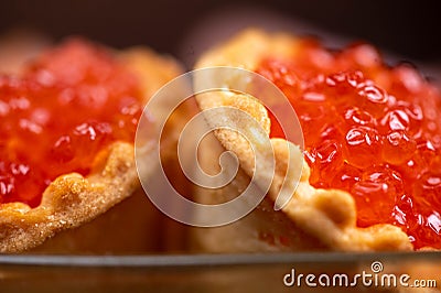 Salmon caviar in a tartlet on a glass dish. Festive table setting Stock Photo