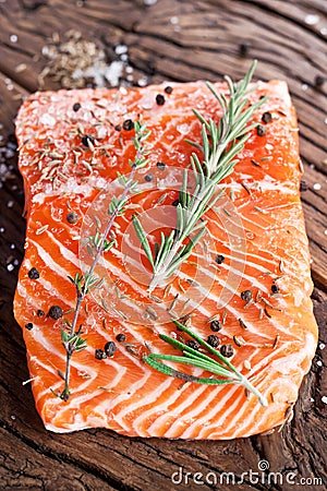 Salmon filet on a wooden carving board. Stock Photo