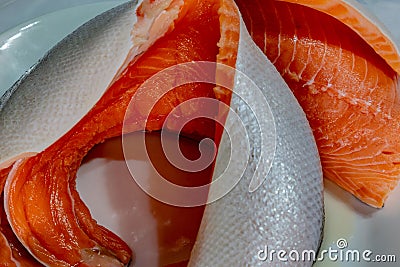 Salmon fillet showing glistering skin and pink meat Stock Photo