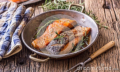 Salmon fillets. Grilled salmon, sesame seeds herb decorationon on vintage pan or black slate board. Stock Photo