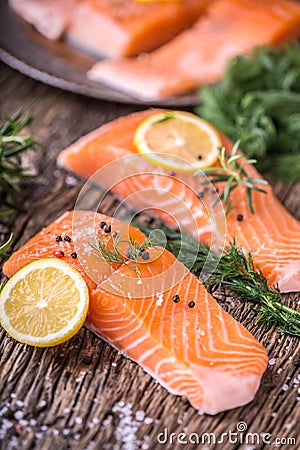 Salmon Fish..Raw salmon fillet pepper salt dill lemon rosemary on wooden table Stock Photo