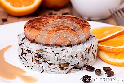 Salmon medallion with mixed cooked rice on white plate Stock Photo