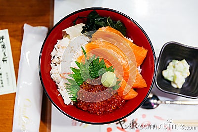 Salmon rice bowl served with ikura salmon roe, crab, seaweed and wasabi at the restaurant in Sapporo in Hokkaido, Japan Stock Photo