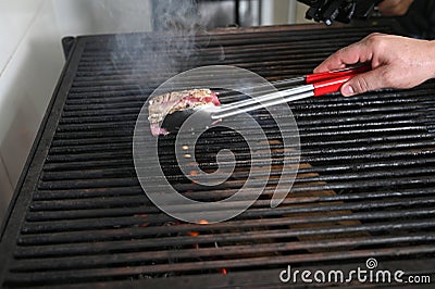 salmon roasted on charcoal barbecue lit wood with fire for roasting fish on the grill Stock Photo
