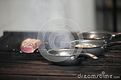 salmon roasted on charcoal barbecue lit wood with fire for roasting fish on the grill Stock Photo