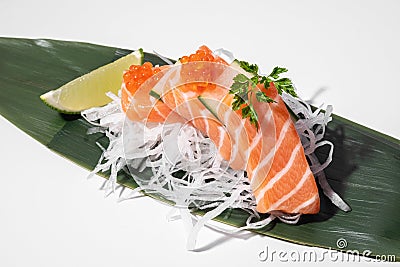 Salmon sashimi on white background. Traditional Japanese food. Raw salmon fish served with red trout caviar. Sushi restaurant menu Stock Photo