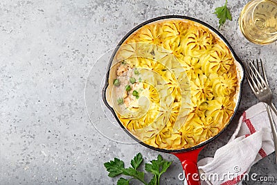 Salmon shepherd`s pie. Fish in creamy sauce , mashed potatoes and vegetables casserole in enamel cast iron pan Stock Photo