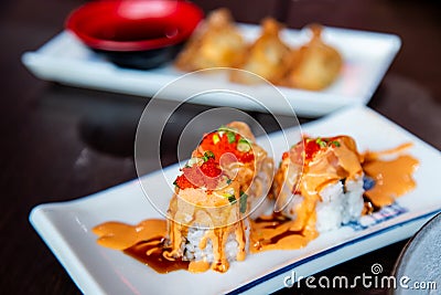 Salmon Spicy Rolls on the White Dish with Fried Crunchy Bread Stock Photo