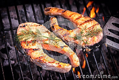 Salmon steaks cooking on barbecue grill for summer outdoor party Stock Photo