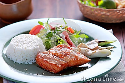 Salmon teriyaki served with rice and salad Stock Photo