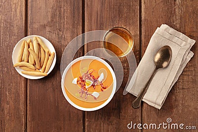 Salmorejo, Spanish cold tomato soup, top shot on a rustic background with wine Stock Photo
