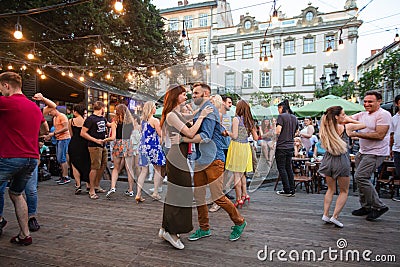 Salsa dancers in outdoor cafe near Diana fountain at Market square in Lviv Editorial Stock Photo