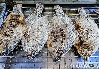 Salt crusted grilled Tilapia on the grill, Special Menu for Thai People - Thai Food Stock Photo