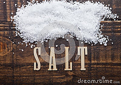Salt on grunge wooden board with letters below Stock Photo
