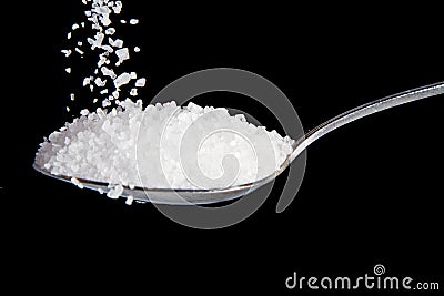 Salt on a metal spoon Stock Photo