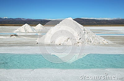 Salt piles and water pool on Salinas Grandes Stock Photo