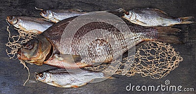 Salted and dried bream and several roach on black surface Stock Photo