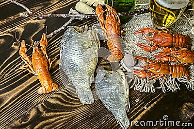 Salted and dried carps with red cancers with filled glass with foamy beer Stock Photo