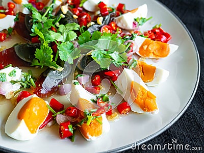 Salted egg and Century egg salad Thai food menu,Spicy, sour, salty, sweet taste. Main ingredients,Salted egg Stock Photo