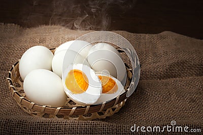 Salted eggs, boiled and ready to eat, put on basket, blurred background Stock Photo