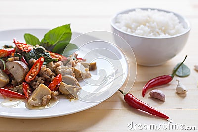 Salted pork with chili & Basil leaves and rice in plate Stock Photo