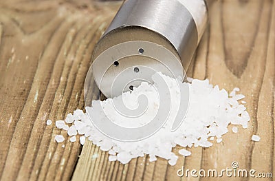 Saltshaker with Salt on wood Stock Photo