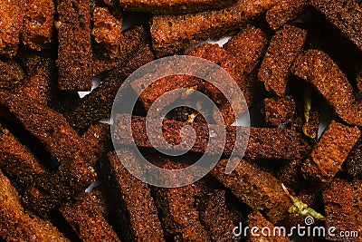 Salty croutons of brown bread with garlic and salt. Fried croutons closeup. Beer snack Stock Photo