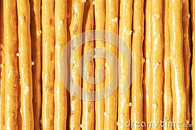 Salty sticks line in row background. Top view. Snack texture background. Salty bread sticks for beer background pattern Stock Photo