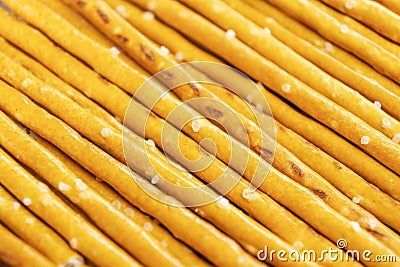 Salty sticks line in row background. Top view. Snack texture background. Salty bread sticks for beer background pattern Stock Photo