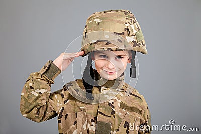 Saluting soldier. Young boy dressed like a soldier Stock Photo