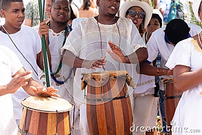 candomble members are playing percussion instruments during the party for yemanja Editorial Stock Photo