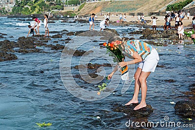 Candomble people are seen throwing flowers into the sea in honor of Iemanja Editorial Stock Photo