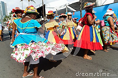 Salvador, Bahia, Brazil - February 11, 2023: Women members of a cultural group are seen during the Fuzue parade, pre-Carnival in Editorial Stock Photo