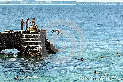People and tourists are on top of the stone pier of Porto da Barra Editorial Stock Photo