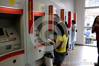 Use of ATM in bank Editorial Stock Photo