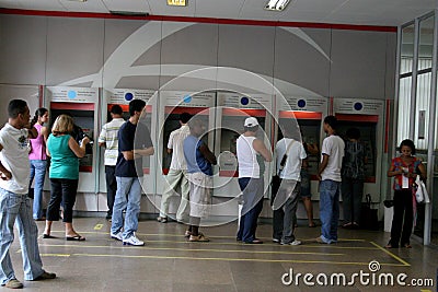 Use of ATM in bank Editorial Stock Photo