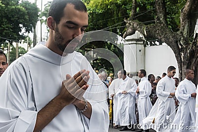 A young priest prays during the Corpus Christ procession Editorial Stock Photo