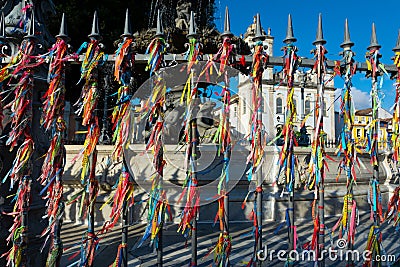 View of hundreds of souvenir ribbons tied to an iron railing in Largo Terreiro de Jesus, Pelourinho, historic center of the city Editorial Stock Photo