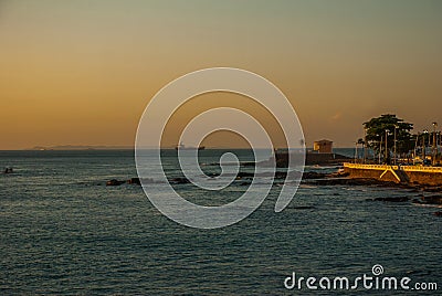 SALVADOR, BRAZIL: Colonial Fort Santa Maria in Barra Salvador Brazil built on tropical beach with palm trees Stock Photo