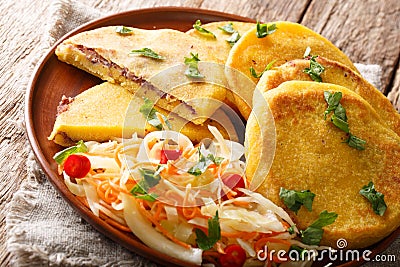 Salvadoran food fried Pupusas served with coleslaw close-up on a plate. horizontal Stock Photo