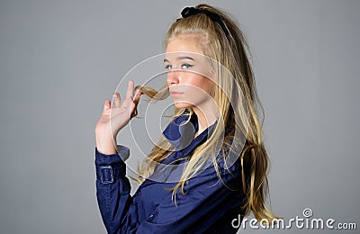 Salvaged my bleached hair. How to take care of bleached hair. Girl tender blonde makeup face grey background. How repair Stock Photo