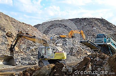 Salvaging and recycling building and construction materials. Excavator with hydraulic hammer work at landfill with concrete Editorial Stock Photo