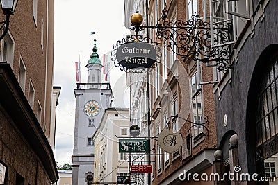 Salzburg, Austria, 28 August 2021: Grain Lane or Getreidegasse famous shopping narrow street in historic Altstadt, wrought iron Editorial Stock Photo