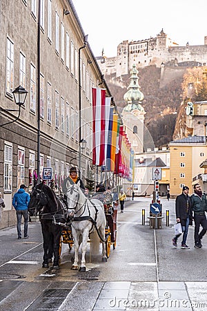 Nostalgic horse driven coach giving visitors a city tour in Salzburg, Austria Editorial Stock Photo