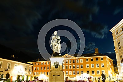 Statue Mozart in Square at night illuminated and golden in colo Editorial Stock Photo