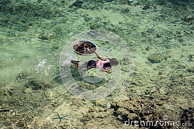 Sama-Bajaus child swims and hunt sea urchin in crystal clear ocean Editorial Stock Photo