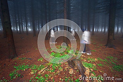 Same female figure walking in forest Stock Photo