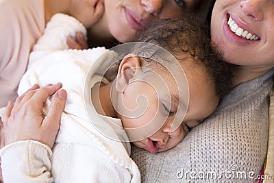 Same sex couple snuggling their son Stock Photo