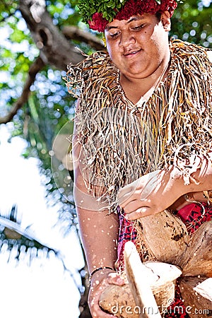 Samoan is opening coconut Editorial Stock Photo